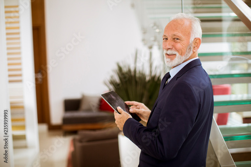 Senior businessman using digital tablet in the office