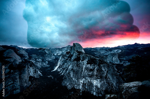 Huge cloud overing over a mountain at sunset photo