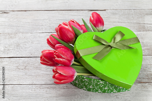 Red tulip flowers and heart gift box