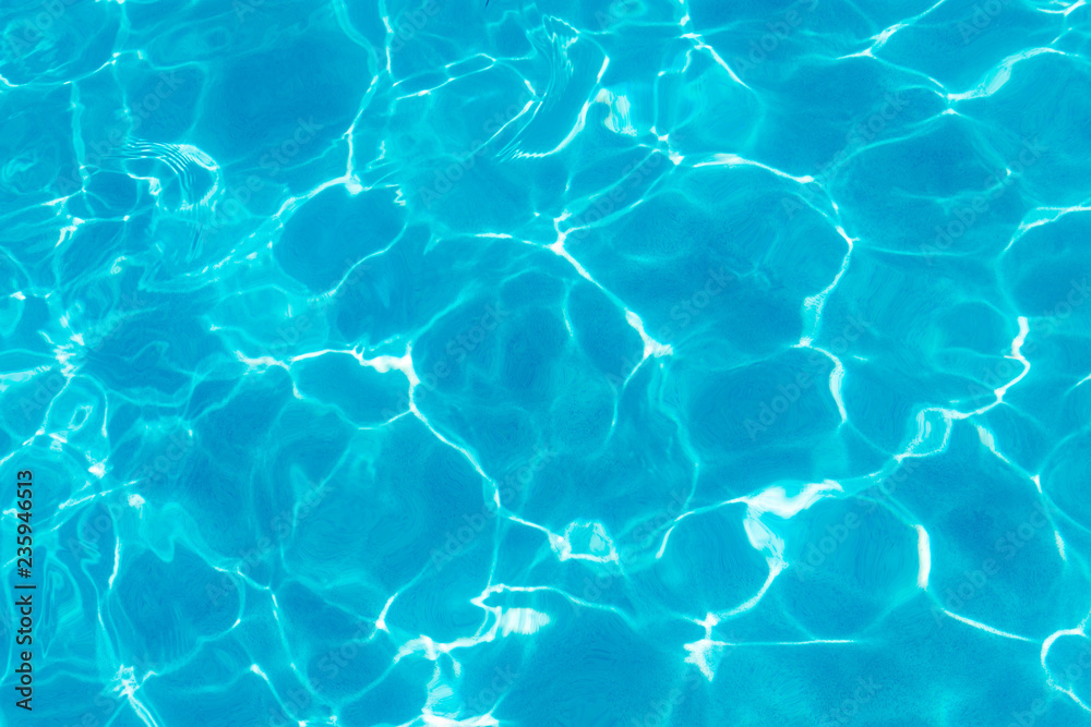 Water ripples and pattern on swimming pool surface with sunlight reflection