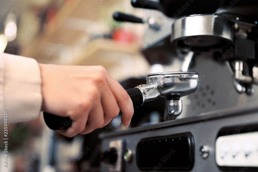 Barista preparing coffee using modern machine, closeup Barista preparing coffee using modern machine, closeup