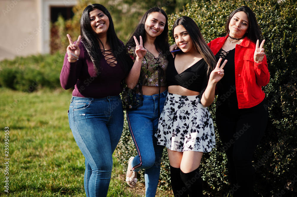 Group of four happy and pretty latino girls from Ecuador posed at street. Group of four happy and pretty latino girls from Ecuador posed at street.