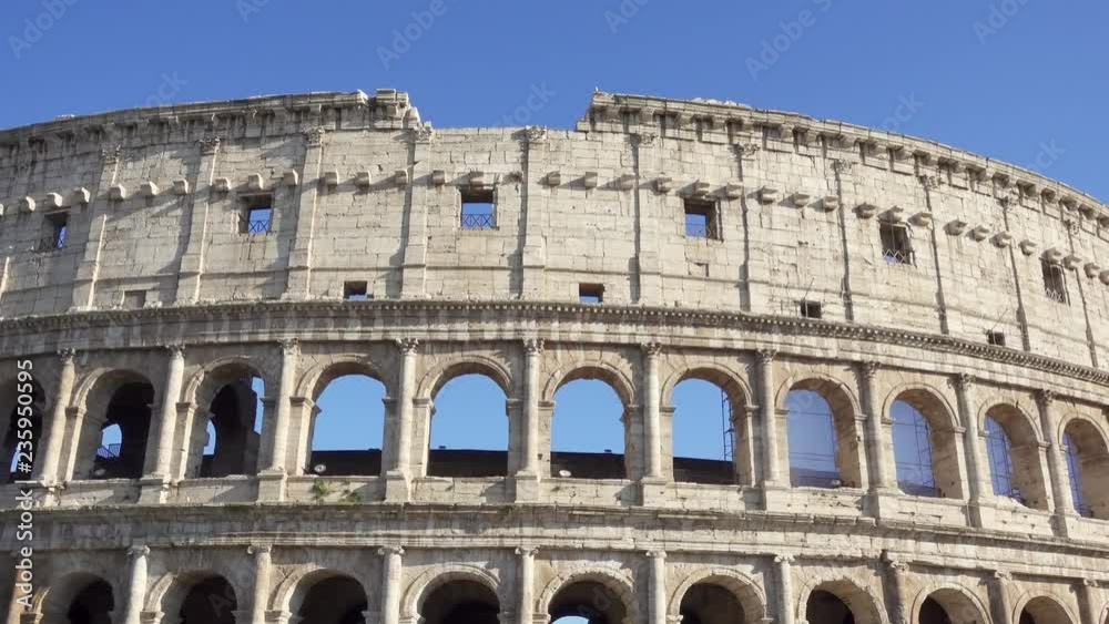 Famous Italian attraction Colosseum in Rome. Veiw on ancient Flavius amphitheater Coliseum in capital of Italy. Camera moving from right to left Famous Italian attraction Colosseum in Rome. Veiw on ancient Flavius amphitheater Coliseum in capital of Italy. Camera moving from right to left