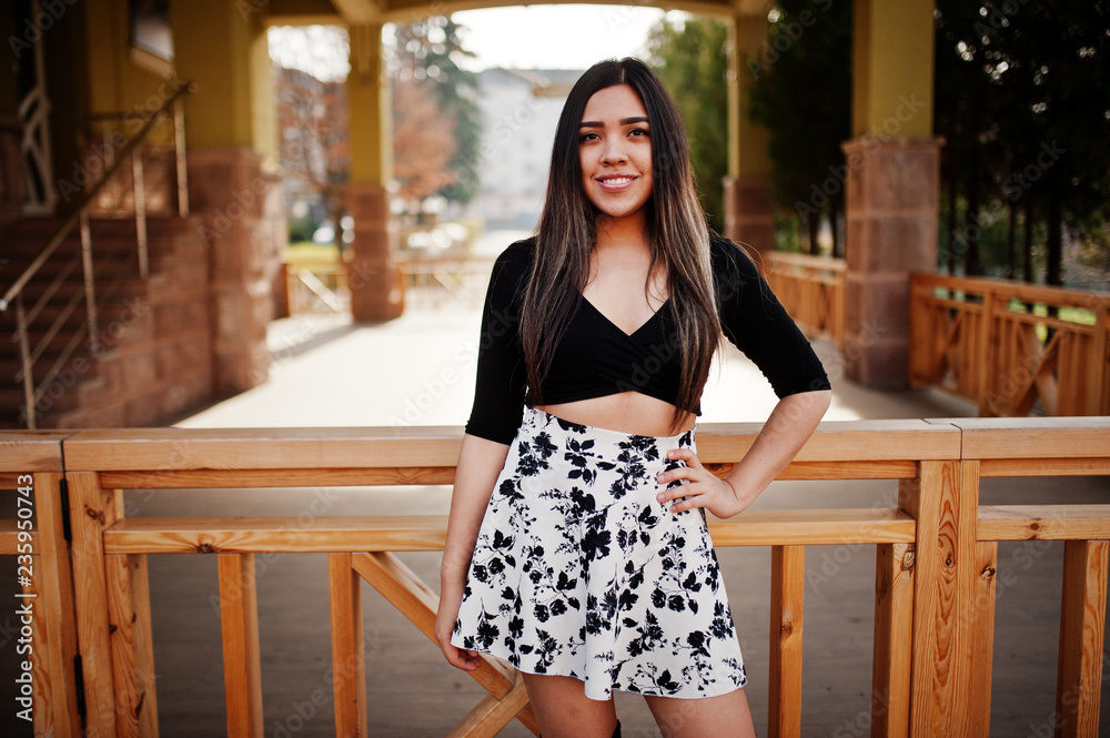 Pretty latino model girl from Ecuador wear on black tops and skirt posed at street. Pretty latino model girl from Ecuador wear on black tops and skirt posed at street.