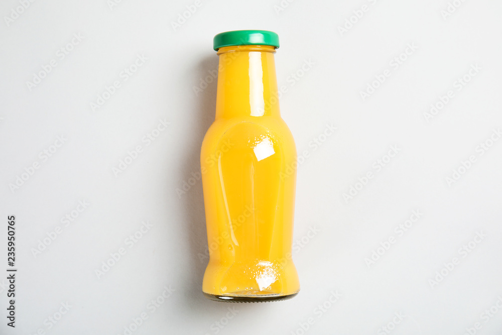 One bottle with tasty drink on color background, top view One bottle with tasty drink on color background, top view