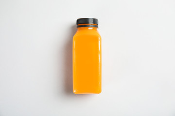One bottle with tasty drink on color background, top view