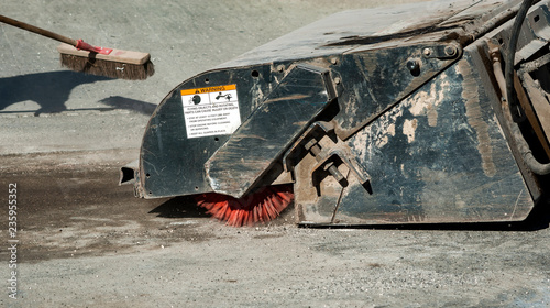 Sweeper attachments mini excavator. The sweeper sweeps, collects and dumps dirt and debris.