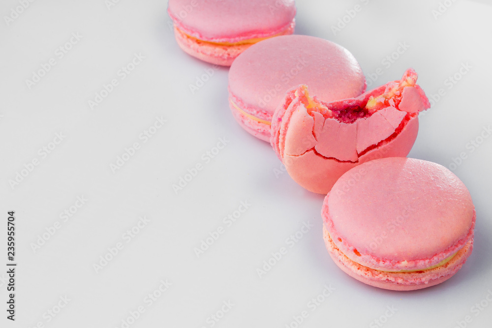 French macarons. Stack pink rose macaron on white background. Colorful macaroons French macarons. Stack pink rose macaron on white background. Colorful macaroons
