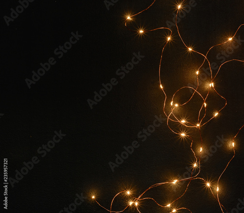 Dark Christmas background with small lights. Place for text. Blank for postcard or poster.