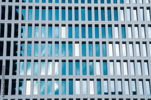 Office building windows background. Abstract geometrical pattern formed by architectural elements. Concrete modular structure. Contemporary building.