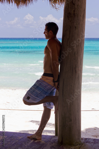 Junger Mann am Strand von Xpu Ha in Mexico auf der Halbinsel Yucatan bei Tulum photo