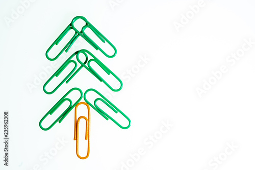 Green christmas tree from color paperclip on white background isolated