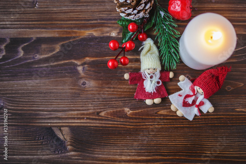 Christmas decorations, burning candles, spruce on a wooden background. New Year's concept. Postcard
