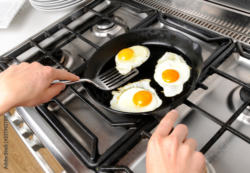 MAN FRYING EGGS photo