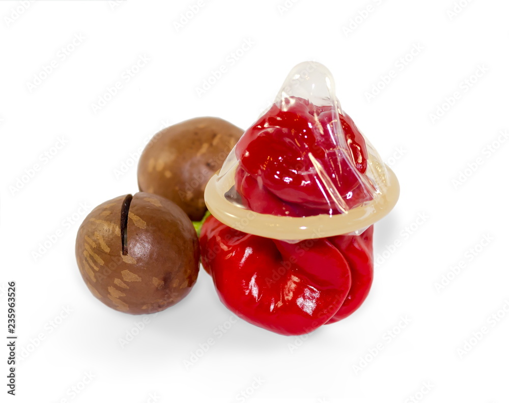 Condom on hot chili pepper isolated on white background. Safe sex concept.  Prevention of sexually transmitted diseases. Peter pepper or Penis or Chilli  Willy variety and Macadamia nuts Stock Photo | Adobe
