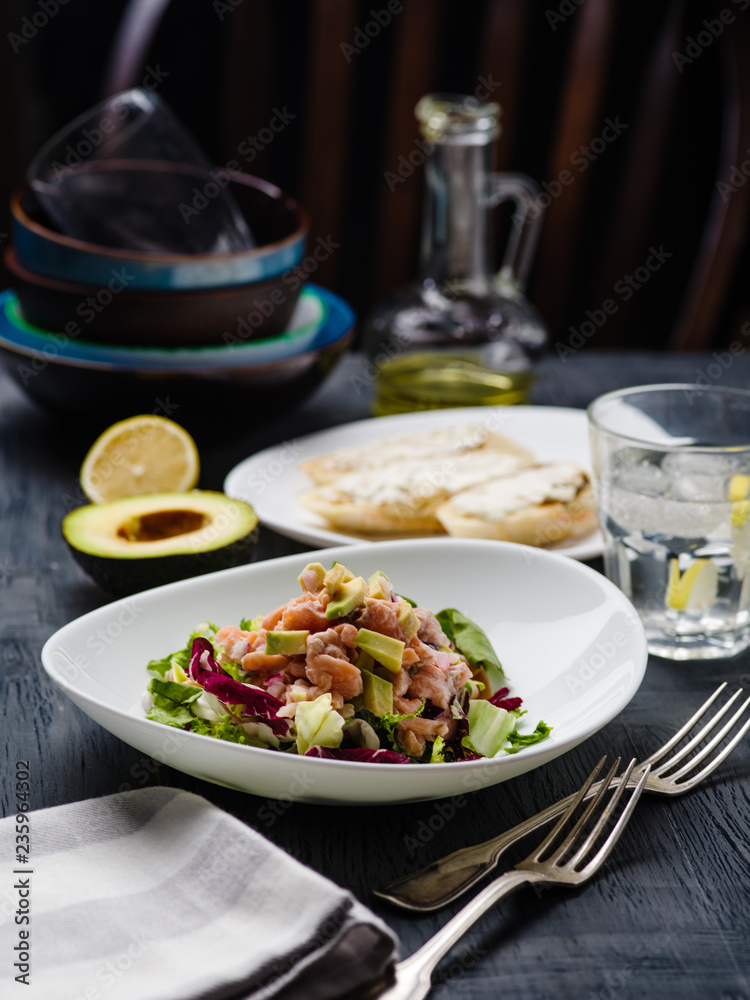 Ceviche is a traditional dish from Peru. Salmon marinated in lemon with fresh lettuce, avocado and onions