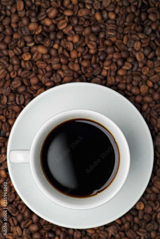 Cup of coffee against a background of coffee beans Cup of coffee against a background of coffee beans