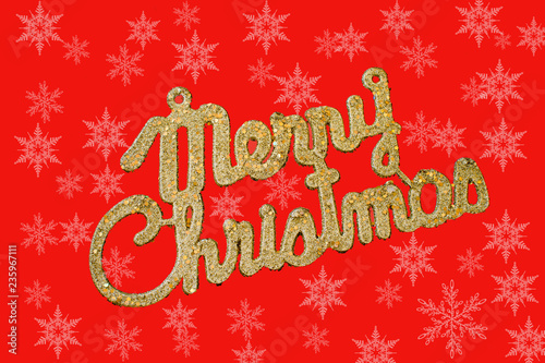 Merry Christmas golden text on a red background with snowflakes 