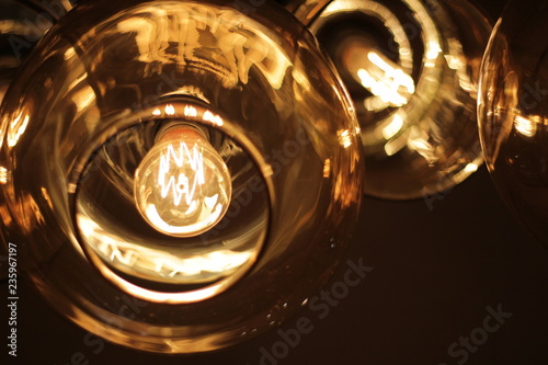 classic edison bulb in a transparent glass ceiling on a black background..concept  cafe interior design element