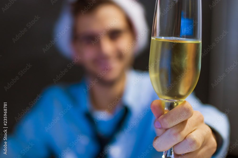 businessman smiling with glass of champagne in the office businessman smiling with glass of champagne in the office