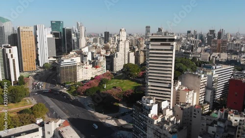 Panoramic Aerial drone view of San Martin park in Retiro, Buenos Aires, with modern and old skyscraper buildings. Street traffic below. Argentina.