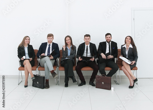 business team sitting in the lobby before the briefing