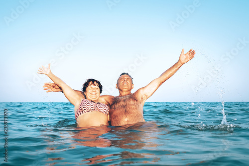 A happy caucasian senior couple enjoys their sea vacation on the beach © Soloviova Liudmyla