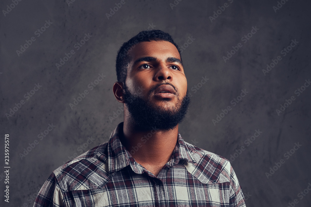 African-American guy with a beard wearing a checkered shirt