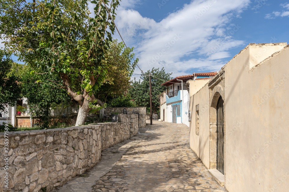 Way through a lonely mountain village on Crete Island, Greece with a small house and some trees