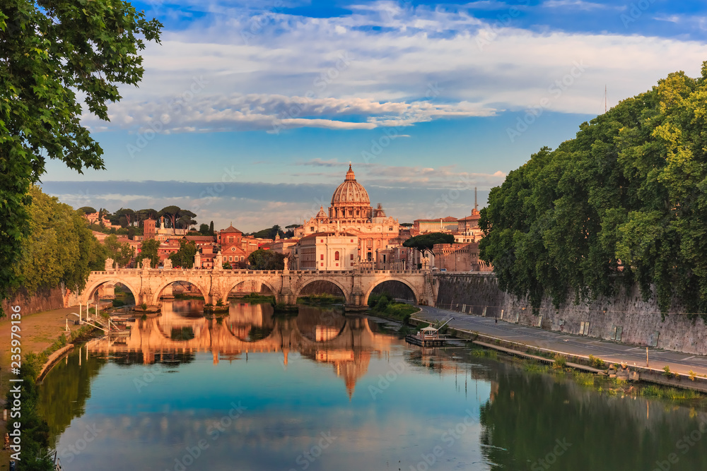 Saint Peter Cathedral and Saint Angel bridge over the Tiber River in the morning in Rome, Italy. Saint Peter Cathedral and Saint Angel bridge over the Tiber River in the morning in Rome, Italy.