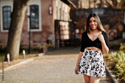 Pretty latino model girl from Ecuador wear on black tops and skirt posed at street. © AS Photo Family