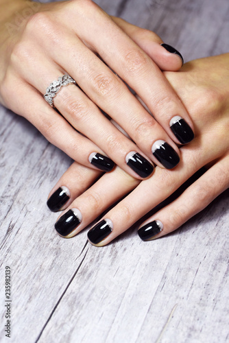 Beautiful hand with black manicure nails