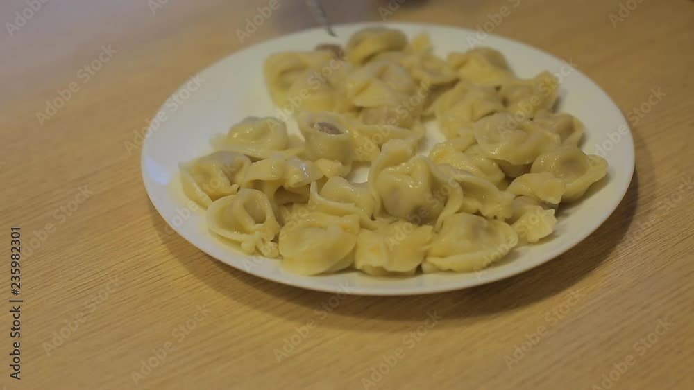 man eating dumplings with beef at home in the kitchen man eating dumplings with beef at home in the kitchen