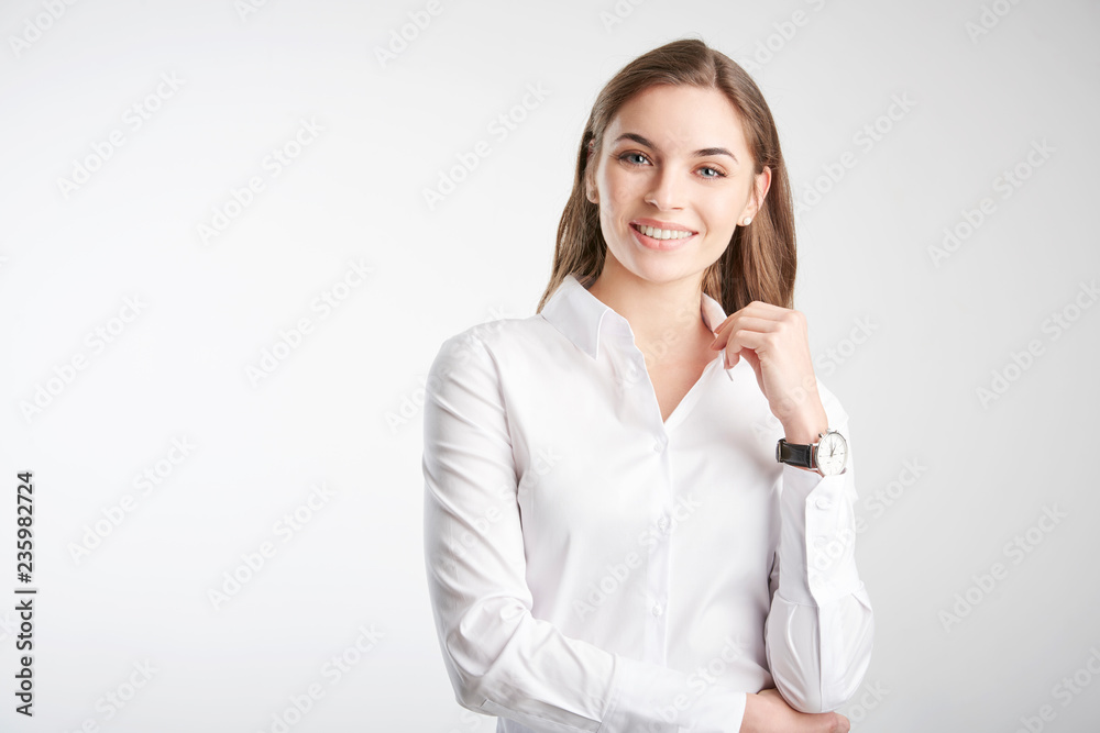 Portrait of an attractive young woman standing against white background Portrait of an attractive young woman standing against white background