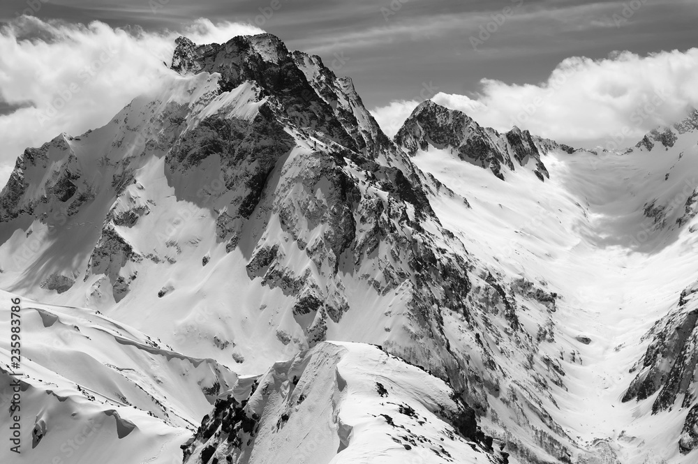 Black and white winter mountains with snow cornice