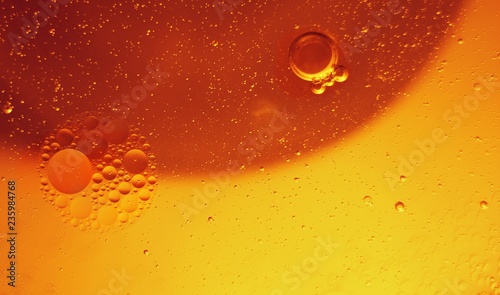 Yellow bubbles and drops of oil and water  beer and beverage texture background.