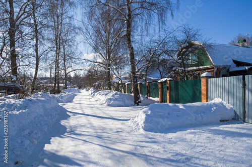 Village street on a sunny winter day. © Sergey Rybin