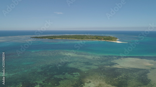Tropical island with white sandy beach. Aerial view: Magalawa island with colorful reef. Seascape, ocean and beautiful beach paradise. Philippines,Luzon. Travel concept.