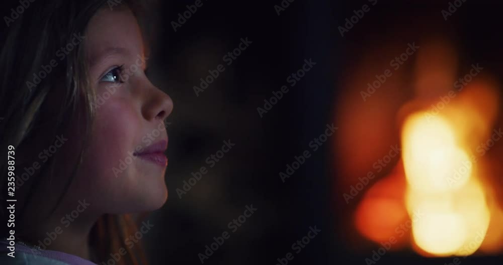 Portrait of a little girl (kid) smiling and looking out of a window. Portrait of a little girl (kid) smiling and looking out of a window.