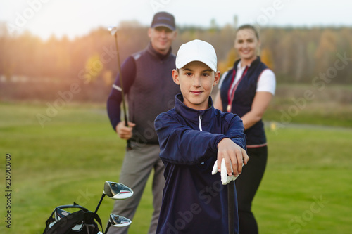 Happy family is playing golf in autumn