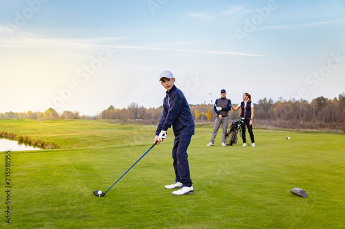 Happy family is playing golf in autumn