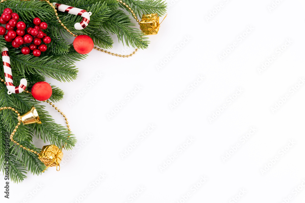 Christmas background concept. Top view of Christmas gift box red balls with spruce branches, pine cones, red berries and bell on white background. Christmas background concept. Top view of Christmas gift box red balls with spruce branches, pine cones, red berries and bell on white background.