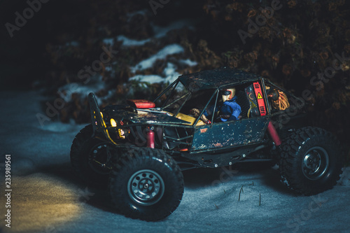 radio-controlled car in the snow at night, lights shine. Christmas present rc car