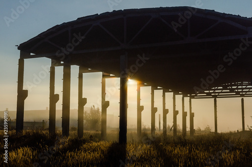 Abandoned hangar at dawn close-up. Concrete supports and floors of an old abandoned hangar © Ivan