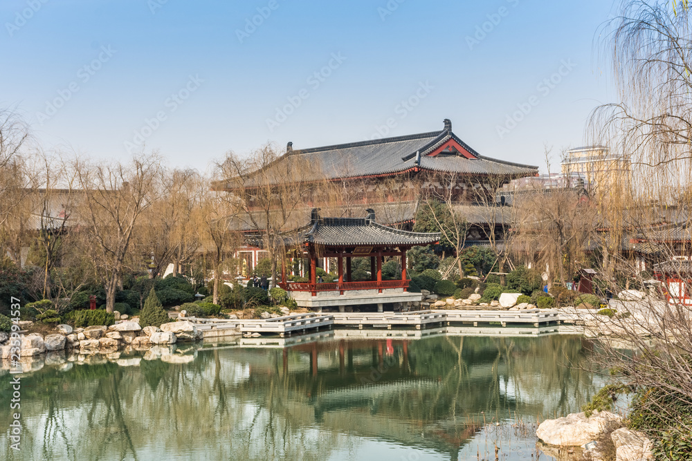 HUAQING, CHINA, 25 DECEMBER 2017: Landscape of a lake and a traditional chinese temple in Huaqing Palace HUAQING, CHINA, 25 DECEMBER 2017: Landscape of a lake and a traditional chinese temple in Huaqing Palace