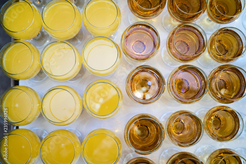 Wine glasses and orange juice glass on a white table background