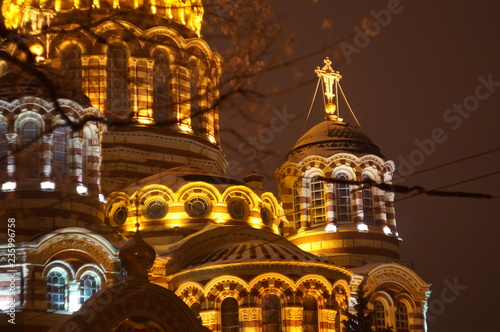 Salisbury seen through trees at night, after a fresh snowfall, with the orange glow of the city lights photo