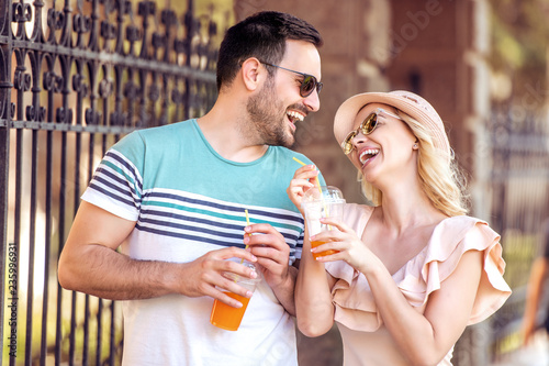 Happy couple in love drinking fresh juice