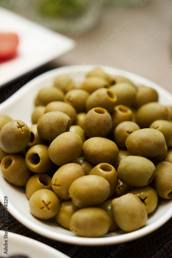 Assortment of fresh olives on a plate, close-up. Healthy snack f Assortment of fresh olives on a plate, close-up. Healthy snack f