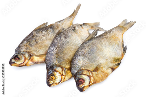three dried salted fishes isolated on white background.